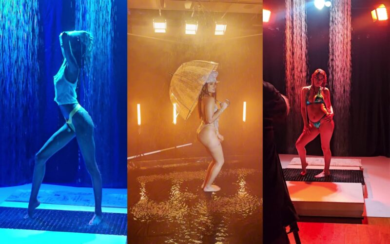 Three frames from the 360ism Rain Room: a model under blue backlit rain, a model with an umbrella in warm gold light and fog, and a model under red backlit rain