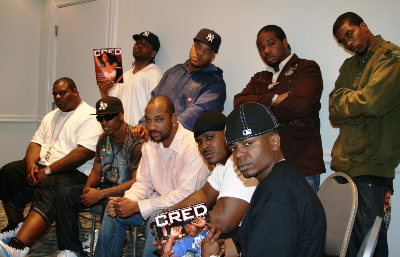 D-Block / The LOX with interviewer LD Williams and musician and producer Elijah LX Harvey, seated and standing in a hotel room, holding copies of CRED Magazine